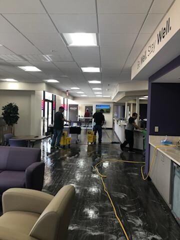 System4 of Houston janitor in Brookside Village, TX mopping floor.